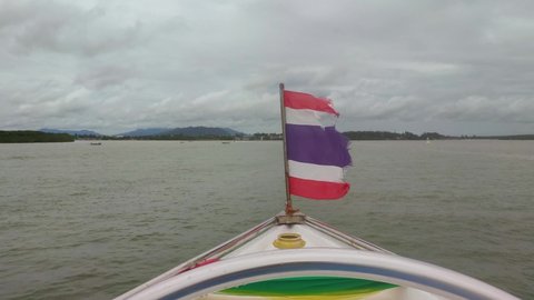 An old torn flag of Thailand on a boat in ocean Thai National Flag
