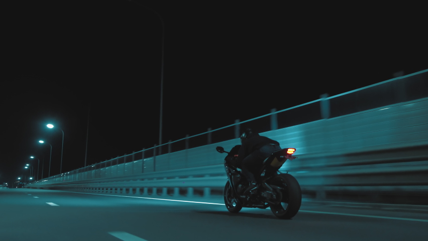 A man rides a sports motorcycle on a night track Royalty-Free Stock Footage #1090133889