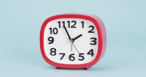 Red Alarm clock isolated on blue background, Showtime 01.55 am, Time concept.