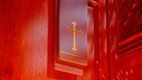 Priest stole with a golden cross in a chapel wooden confessional. Red, hot fire of hell with embers beneath. People are being punished for their sins. Purgatory choice hell or heaven. Religion symbol.