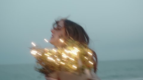 Girl runs to the beach with a cardboard envelope with lights