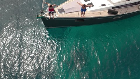 Two guys jumping from a yacht. High quality 4k footage