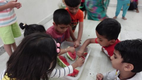 Bangalore, India 9th May 2022: Indian kids enjoying and working in a Fun Summer camp. Teaching cooking and skills in a fun-based camp. Kids and children learning life skills.