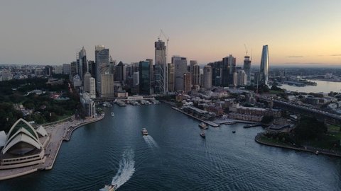 SYDNEY, NSW, AUSTRALIA – MAY 6, 2022: Aerial drone pullback view of Circular Quay on Sydney Harbour in the late afternoon     