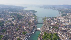 Inscription on video. Zurich, Switzerland. Panorama of the city from the air. View of Zurich Lake. Limmat River Expiry Site, St. Peter Church, Fraumunster Church. Arises from blue water, Aerial View