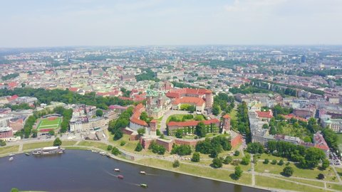 Inscription on video. Krakow, Poland. Wawel Castle. Ships on the Vistula River. View of the historic center. Arises from blue water, Aerial View, Point of interest