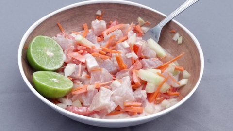 A closeup view of raw fish in coconut milk with lemons, a Polynesian Tahitian meal