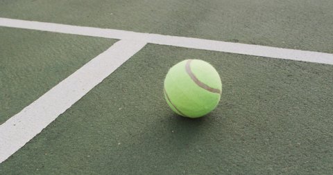Video of tennis ball lying on tennis court. active lifestyle, sport, hobby and tennis training concept.