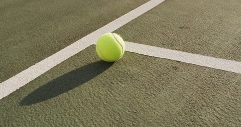 Video of tennis ball lying on tennis court. active lifestyle, sport, hobby and tennis training concept.