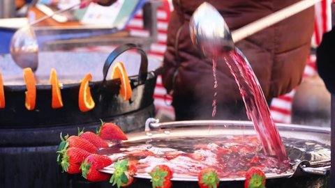 mulled strawberry wine in a metal cauldron that evaporates