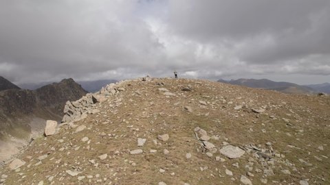 Revealing Shot with person on top of Summit and Valley in Mountain Landscape, Andorra, Pyrenees