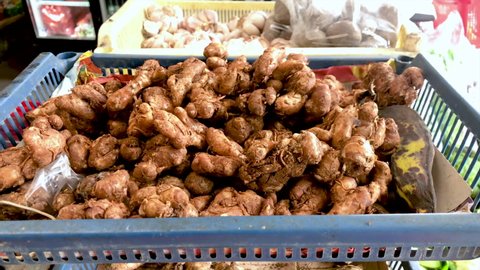 Fresh organic ginger root and other spices and vegetables for sale at vegetable market. Selling vegetables in shop
