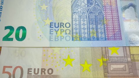 Euro paper currency banknotes zooming slowly. The name of the currency "Euro" in Latin, Greek and Cyrillic transcription close-up. Stars - the emblem of the European Union. EU money.