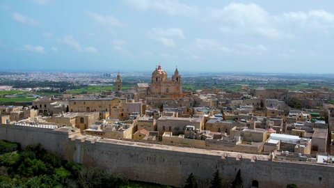Aerial 4K panorama view footage of the town of Mdina fortress in Malta also called Silent city. Ancient medieval walled city - the capital city of Malta in medieval times