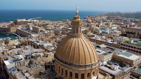 Aerial 4K footage of a drone flight over of Basilica Lady of Mount Carmel church, St. Paul's Cathedral in the old town of Valetta, Malta. Flight around the dome