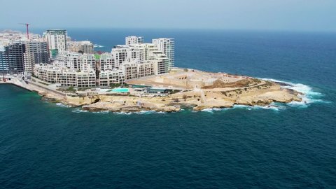 Aerial 4K footage of a drone flight over Slima (Sliema) district with fort Tigne in front of peninsula in Valetta, Malta.