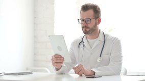 Doctor making Video Call on Tablet in Office 