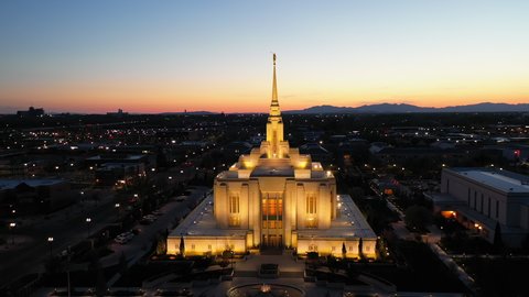 LDS Mormon Temple in Ogden Utah, illuminated at night. Drone pull back