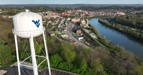 Monongalia County , WV , United States - 04 29 2022: Downtown Morgantown, home of West Virginia University and Monongahela River. Aerial golden hour view.