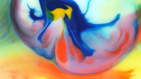 Moving background consisting of blue, yellow, red and green particles of the current paint on a white background. Fluid art.