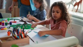 Little kids working on project with teacher during creative art and craft class at school. - Powered by Shutterstock - Get 15% off with code: PIKWIZARD15