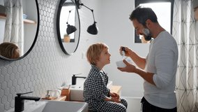 Father with small child indoors in bathroom in the morning at home, shaving. - Powered by Shutterstock - Get 15% off with code: PIKWIZARD15