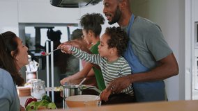 Happy multiracial family with three children cooking together at home. - Powered by Shutterstock - Get 15% off with code: PIKWIZARD15