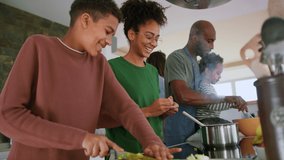 Happy multiracial family with three children cooking together at home. - Powered by Shutterstock - Get 15% off with code: PIKWIZARD15