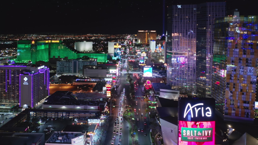 Stunning City View of Futuristic Skyline at Night, Skyscrapers in American Entertainment Capital Las Vegas with flashing lights and Car Traffic Flow on STRIP road. Aerial View Las Vegas, USA Apr 2022