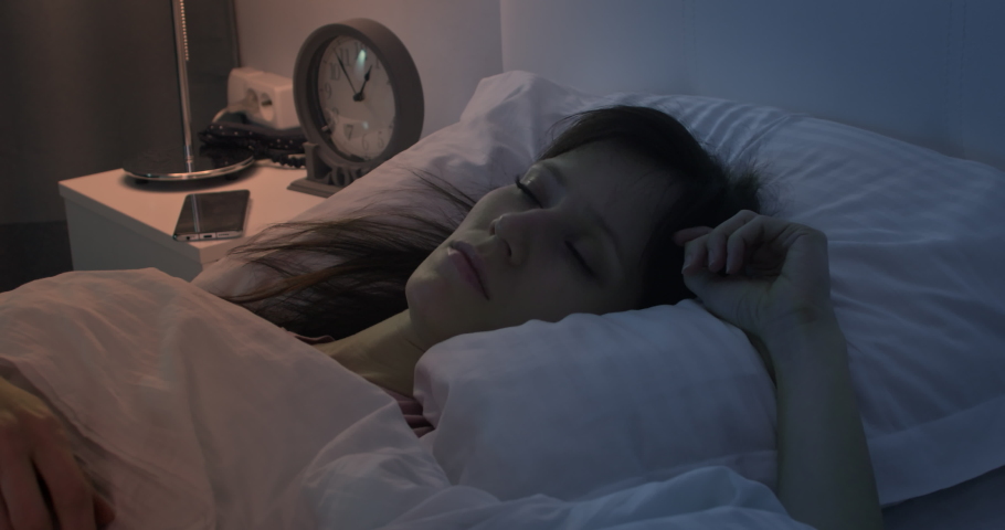 Young stressed woman cannot sleep due to noise of her neighbors, irritated and stressful covers her head and ears with pillow Royalty-Free Stock Footage #1090176811