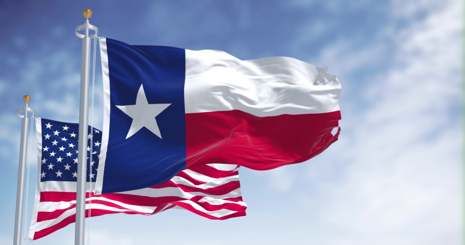 The Texas state flag waving along with the national flag of the United States of America. Texas s a state in the South Central region of the United States | Shutterstock HD Video #1090178989