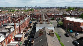 Aerial drone footage of the British town centre of Armley in Leeds West Yorkshire in the UK on a bright sunny summers day showing the roof tops of the back to back terrace houses and homes in the town
