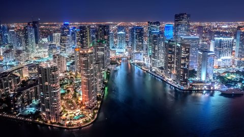 Hyperlapse time-lapse of Beautiful City Skyline at Night Skyscrapers Miami Down Town City Center with flashing lights, Yachts, Boats and Car Traffic. Urban Modern City  Aerial Hyperlapse Time Lapse  Adlı Stok Video
