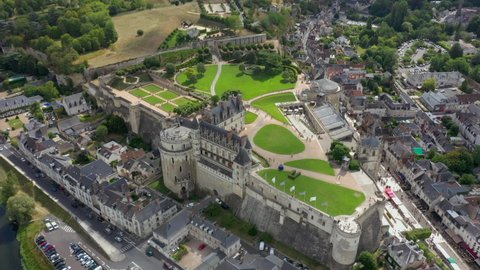 Aerial view of Royal Castle of Amboise in France, luxurious mansion in summer day, green lawns, chapel and river. HD hight quality drone footage