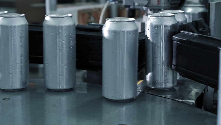 Empty new aluminum cans for drink process are moving in factory line on conveyor belt machine at beverage manufacturing. food and beverage industrial business concept. High quality 4k footage Royalty-Free Stock Footage #1090190743