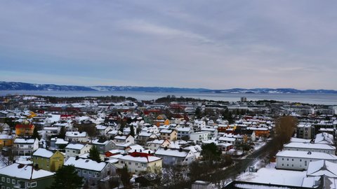 Trondheim, Norway. Aerial view of the city center in spring in Trondheim, Norway with snow. Aerial view of sea and historical colorful buildings