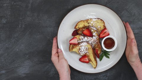 Serving a Plate of French Toast with Strawberries