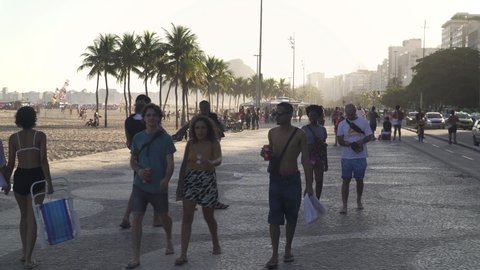 RIO DE JANEIRO, BRAZIL - FEBRUARY 2022: People walk on Copacabana sidewalk in Rio de Janeiro
