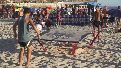 RIO DE JANEIRO, BRAZIL - CIRCA 2022: Young men play Teqball at Copacabana beach in Rio de Janeiro.
