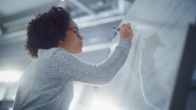 Happy Female Student Thinking about Solving Math Equation in front of Whiteboard. Education, Learning and Startup Concept. Slow Motion - Powered by Shutterstock - Get 15% off with code: PIKWIZARD15