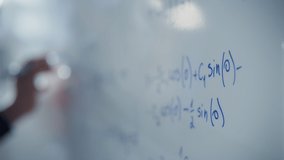 Macro Follow Shot of a Blue Marker Pen Being Held with a Hand. Teacher Writing Equations on a Whiteboard with Mathematical Formulas. Gripped Shot - Powered by Shutterstock - Get 15% off with code: PIKWIZARD15