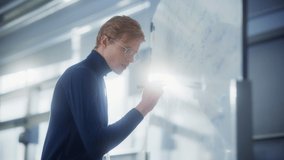 Concentrated Male Young Tutor Writing Long and Complex Equation Formula on Whiteboard. Genius Developing New Theories Concept. Portrait View - Powered by Shutterstock - Get 15% off with code: PIKWIZARD15
