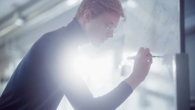 Brilliant Young Academic Writing Big and Complex Mathematical Formula Equation on the Whiteboard. Solving Problems and Searching New Strategies Concept. Portrait View - Powered by Shutterstock - Get 15% off with code: PIKWIZARD15