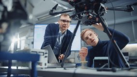 Chief Engineer Look at Drone Attentively While Discussing Design with Promising Scientist. Manufacturing Facility that Creates Great Products. Slow Motion - Powered by Shutterstock - Get 15% off with code: PIKWIZARD15