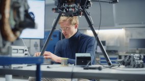 Electronics Male Engineer Works with Drone and Put Microchip at it. Concept of Computer Science Research Laboratory with Working Specialist. Portrait View - Powered by Shutterstock - Get 15% off with code: PIKWIZARD15