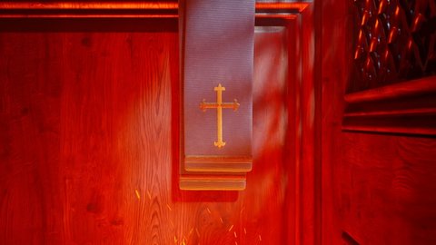 Priest stole with a golden cross in a chapel wooden confessional. Red, hot fire of hell with embers beneath. People are being punished for their sins. Purgatory choice hell or heaven. Religion symbol.