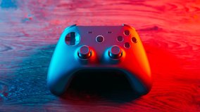 Video games concept. Realistic wireless gamepad for playing games on console or PC. Joystick for a player. Video game controller on the table. Detailed gamepad with sticks and buttons. Fun. - Powered by Shutterstock - Get 15% off with code: PIKWIZARD15