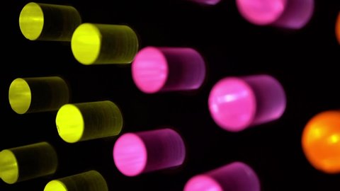 Abstract neon colorful cylinders with luminous bulbs, light music.