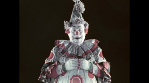 1950s: Clown stands and talks. He pantomimes sleep. He turns and gestures. Leader.
