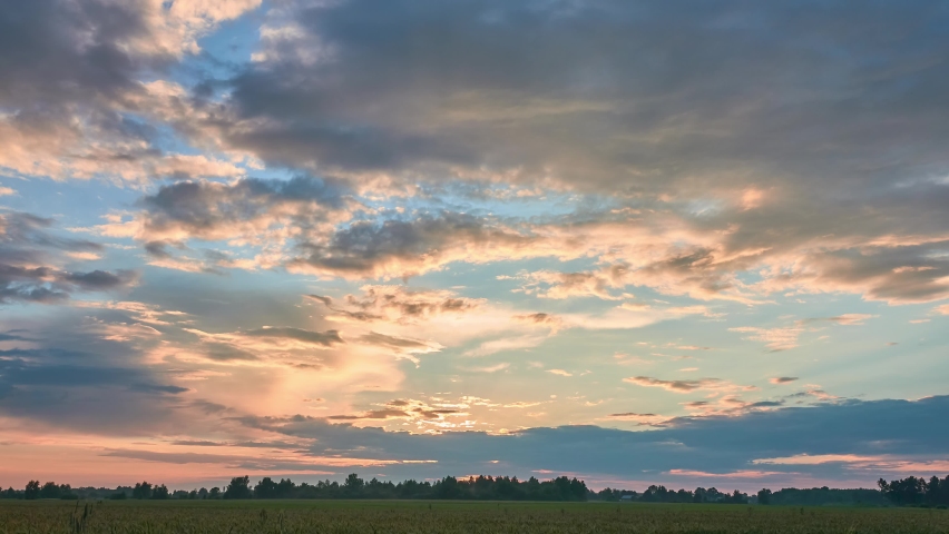 Beautiful sunset sky. Picturesque summer nature. Countryside. Clouds are highlighted by setting sun. Royalty-Free Stock Footage #1090198133